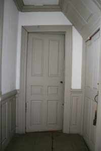 First floor, lobby entry. Six panel door.