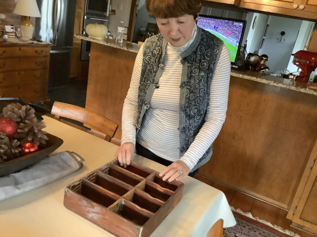 Kathy Santos with the cash box used instead of a cash register
